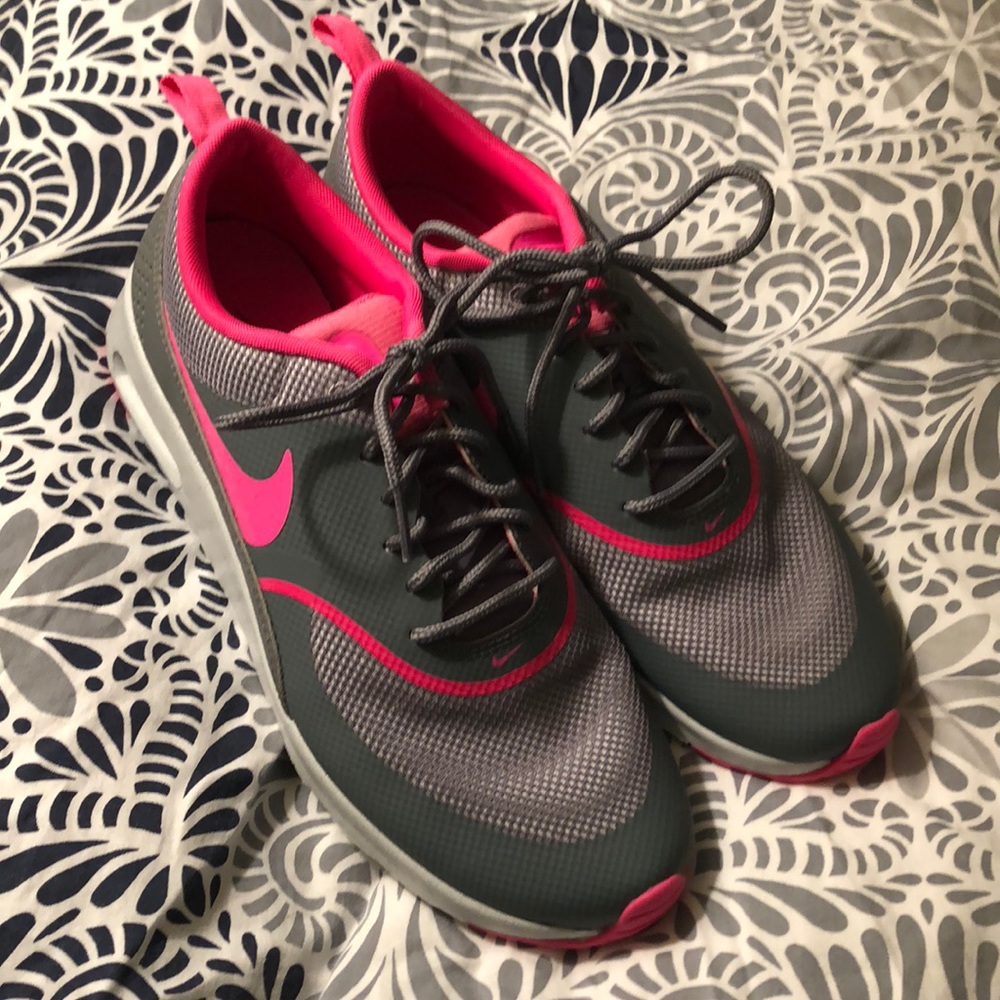 Pink and grey Nike tennis shoes